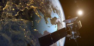 a satellite orbiting the earth with illuminated cities at night, mobile networks in space