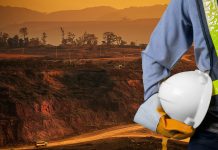 Making a digital difference in the future of mining Engineer holding a white helmet for the safety of mining workers