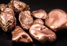 Unearthing a new copper discovery to boost global decarbonisation native copper nuggets isolated on black background, ore for industrial use in electrical wires and household utensils