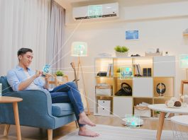 Man,Sitting,On,Sofa,And,Using,Smart,Home,Control