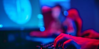 Blurred,Background,Computer,,Keyboard,,Blue,And,Red,Teams,Lights,Concept,Esports