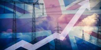 Rising,Up,Arrow,Against,Uk,Flag,And,Power,Line,Silhouette