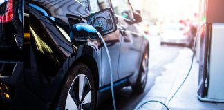 Charging,Modern,Electric,Car,On,The,Street,Which,Are,The