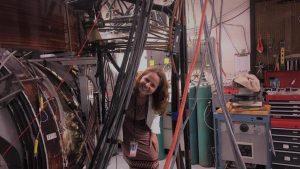 Dr. Evdokiya Kostadinova standing by the Compact Toroidal Hybrid device at the Auburn University's Physics Department, nuclear fusion research