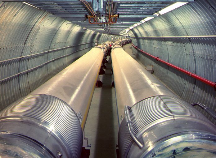 The Relativistic Heavy Ion Collider (RHIC) consists of twin rings of superconducting magnets carrying ions (atomic nuclei stripped of their electrons) in opposite directions (see particles collide). The Electron-Ion Collider (EIC) will reuse one of these ion storage rings and add an electron accelerator, an electron storage ring, and other accelerator infrastructure to collide electrons with protons or ions. (Brookhaven National Laboratory)